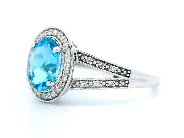 Lady's Split Shank Oval Blue Topaz and Diamond Ring.