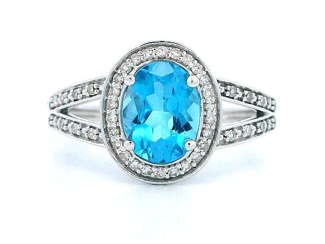 Lady's Split Shank Oval Blue Topaz and Diamond Ring.